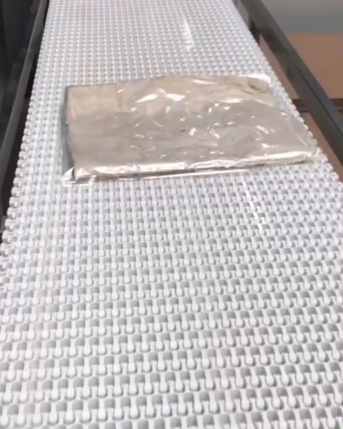 One sealed pack of yufka on the white conveyor in Ermelo